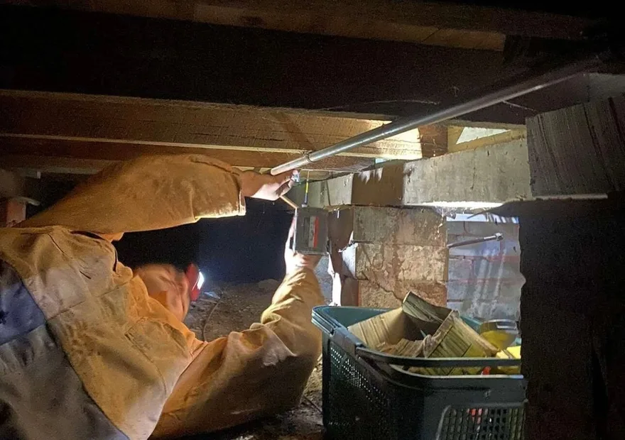 Blocked drain clearing under a Whitsundays home